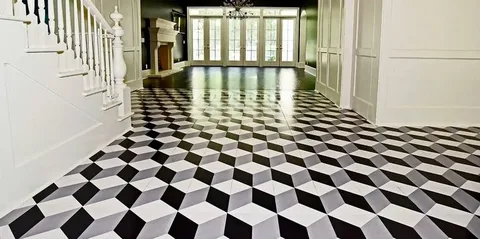 Elegant foyer showcasing a tile installation design with a dramatic black-and-white checkerboard floor, white staircase, fireplace, and tall windows.